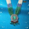 Emerald Blossom Necklace Set with carved emerald pendant and multi-strand green bead necklace, styled for bridal and festive Indian wear.
