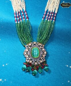 Emerald Blossom Necklace Set with carved emerald pendant and multi-strand green bead necklace, styled for bridal and festive Indian wear.