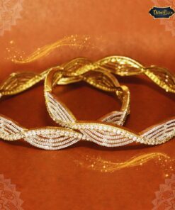 Gold-plated Crowned Whispers Bangles with engraved crown-like design and soft detailing on a royal silk background