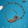 Floral Kundan Bridal Nath with red beads and pearl detailing – elegant traditional nose ring for bridal and cultural wear.