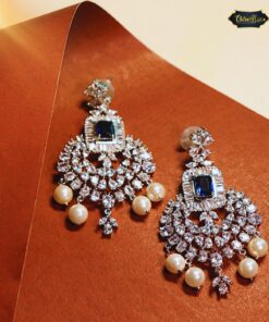 Celeste Blue Stone Chandbali earrings featuring delicate pearls and shimmering crystals in a traditional crescent design.