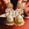 Lotus Bloom Pearl Jhumka Earrings featuring intricate lotus designs with cascading pearls, perfect for traditional and festive occasions.