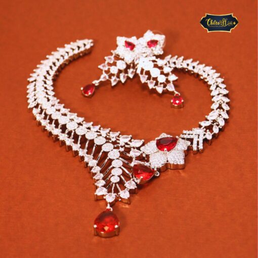 Red necklace set with dazzling stones and matching earrings designed to add bold elegance to any outfit.