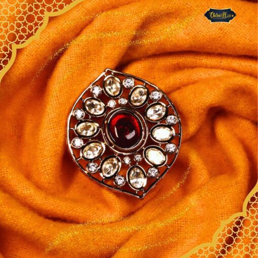 Maharani Ruby Halo Ring featuring a vibrant central ruby surrounded by a sparkling halo of accent stones in an elegant setting