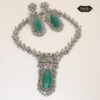 Close-up of a sparkling mint green teardrop CZ choker necklace with matching earrings on a soft, light-colored background.