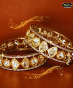 Gold-plated Celestial Dew Bangles with sparkling stone detailing, displayed on a velvet fabric background