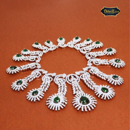 Emerald Bridal Set featuring a green teardrop necklace and matching earrings with a silver finish, ideal for elegant bridal wear.