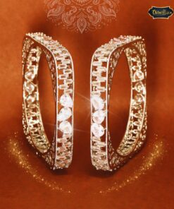 Gold-plated Twilight Grace Bangles with intricate engraving and soft twilight-inspired design, displayed on an ethnic fabric background