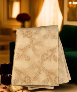 Handwoven beige-golden Banarasi saree made of pure Katan silk, featuring intricate floral motifs and subtle zari work, displayed elegantly.