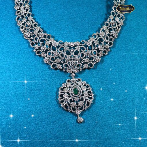 Vintage filigree emerald choker set with green gemstones and matching earrings, ideal for Indian bridal wear and festive traditional outfits.