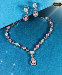 Pastel Dream Jewelry Set with soft pink and green stones featuring a delicate necklace and matching earrings on a neutral background.