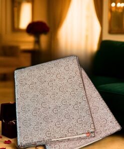 Elegant designer woolen shawl with intricate floral patterns, displayed alongside a Heritage Banaras Silk Saree in a cozy, luxurious interior setting.