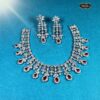 Crimson Radiance Necklace Set with teardrop ruby stones and floral motifs, including matching earrings—ideal for weddings, parties, and elegant festive looks.
