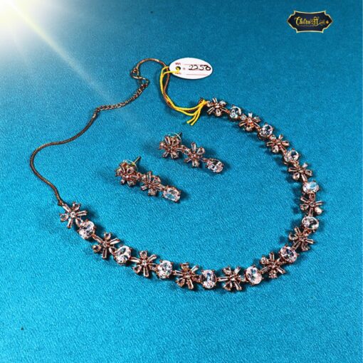 Golden Frost Necklace with white crystals and a gold floral pendant, including matching earrings for a complete, elegant jewelry set ideal for special occasions.